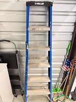 Blue Keller fiberglass stepladder with aluminum treads
