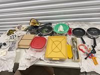 Entire lot laid out on table showing cookware, containers, utensils, oven mitts