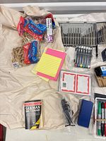 Overview of rubber bands, index pads, dictionary, markers, hole punch, bit set