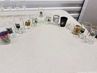 Wide view of all shot glasses and vases lined on table