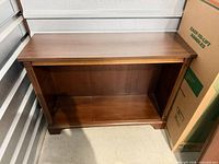 front view of bookcase showing open interior and bracket feet