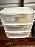 Front view of white 3-drawer plastic organizer with translucent drawers