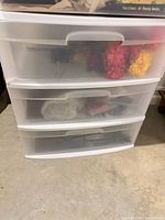 Front view showing three translucent drawers within white frame