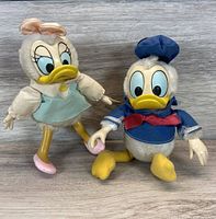 Donald and Daisy Duck plush figures standing side by side