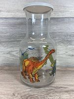 Front view showing Brontosaurus graphic on glass carafe