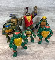 Front view of all seven TMNT figures standing