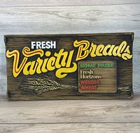 Front view of carved wood bread advertising plaque