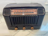 Front view showing dial, grille, knobs