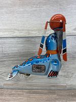 Right side view of Blic tin seal balancing red ball