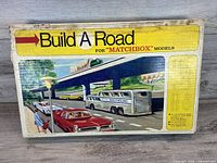 Illustrated front of Build A Road box for Matchbox models