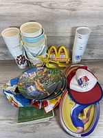 Group shot of entire lot showing cups, pails, plates, arches, caps and booklet