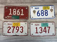 All four New Hampshire Contract Carrier plates displayed