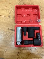 Open red case showing all five tool pieces in molded slots