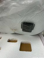 Rear view showing battery movement on clock back within plastic