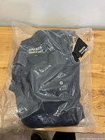 Jumper sealed in clear plastic bag, overall view