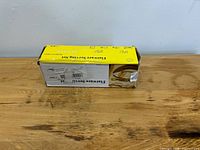 Exterior of damaged yellow and white retail box on table