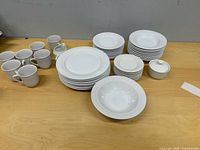 Full set stacked on table showing plates, bowls, mugs, creamer, sugar bowl