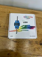 Front of box showing blue digital mini crane scale illustration and model MNCS-M