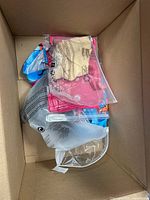 Top view of cardboard box showing several sealed clothing items
