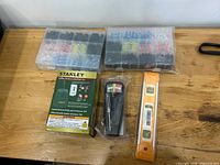 Overview of all items: two connector boxes, Stanley tester box, black tester with screwdriver, orange level