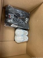 Two sealed pairs of shoes inside the carton