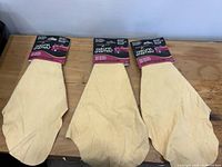 Three packaged natural chamois cloths on table