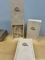 Three wooden wine boxes standing and lying to show lids and size