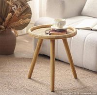 stock image of assembled rattan side table with three legs