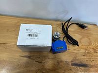 Valve with actuator, power cord and box on tabletop