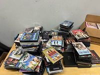 Wide view of multiple stacks of DVDs on table