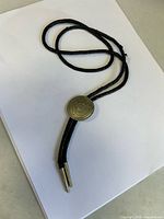 Full bolo tie showing cord, slide and tips