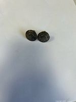 front view of cufflinks showing calendar design