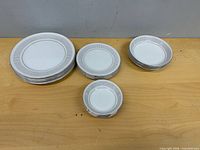 All 16 Yamaka pieces arranged in groups by size on tabletop