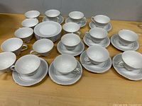Overall view of Yamaka tea cups and saucers laid out on table
