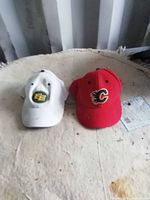 White and red sports hats side by side