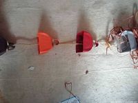 Close view of middle sections with orange and red bell shapes on twine