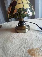 Side view of lamp showing base, cord and portion of shade