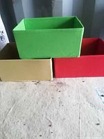 Three felt boxes shown (green, beige, red); two included per seller; demonstrates colors and construction