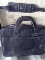HP black laptop briefcase front with handles and strap pad showing HP logo