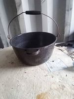 Overall view of speckled enamel stock pot on surface