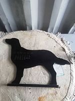Front view of wooden dog silhouette calendar on base