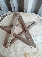 Front view of rustic wooden star on fabric surface