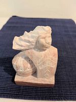 Front view of alabaster bust with geometric etching