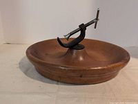 Overall view of wood bowl with mounted metal nutcracker