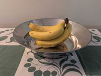 Top view of mirror-finish aluminum bowl on table