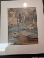 Framed pastel artwork showing dock buildings and boats, signature visible bottom right