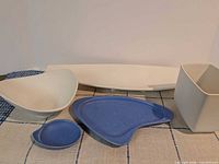 Pair of blue atomic form dishes shown front and side