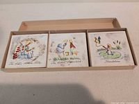 Box with three coasters visible (The Little Match Seller, The Little Shepherdess?, Thumbelina)