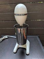 Full view of Hamilton Beach DrinkMaster mixer with cup attached