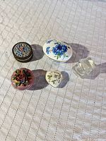 Five items arranged closed showing exterior designs and two glass cubes